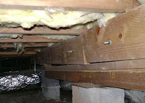 sagging crawl space with wooden shimming a Stillwater crawl space