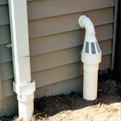 A grated sump pump discharge line fitting in Hastings
