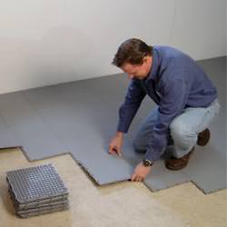 basement subfloor tiles being installed by a contractor in Prior Lake