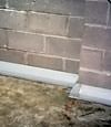 Our baseboard drain system installed on a corner in a Blaine basement.