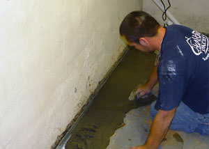 Restoring a concrete slab floor with fresh concrete after jackhammering it and installing a drain system in Prior Lake.