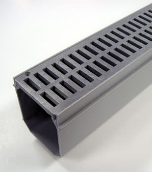 A closeup of our grated basement drainage pipe system, installed in Austin