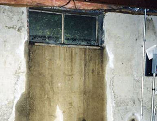 Water pouring out from a basement window in Burnsville